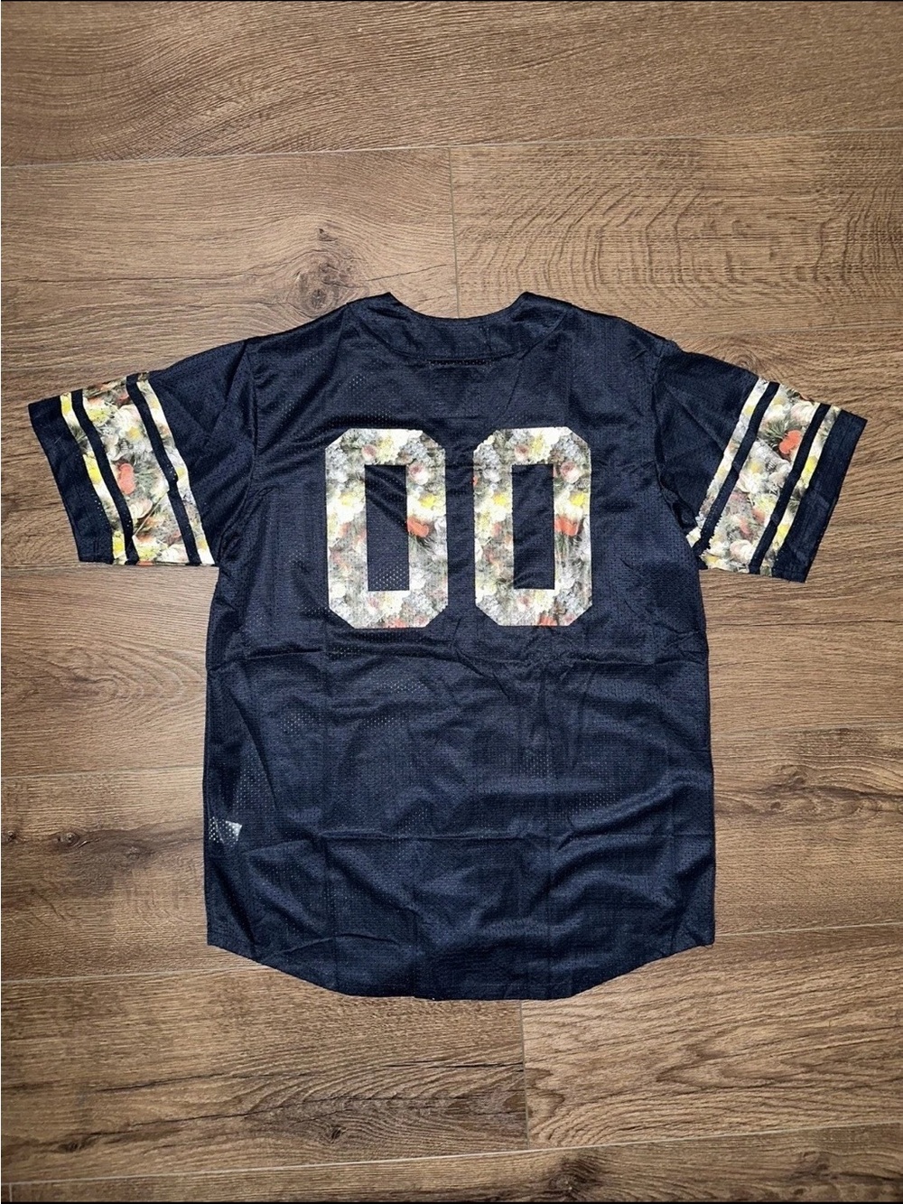on the byas Navy Mesh Jersey with Floral '00' and Gold Trim